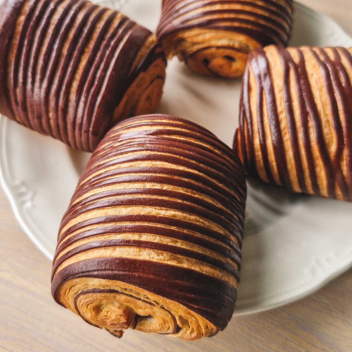 Four delectable chocolate breads, arranged beautifully on a plate.