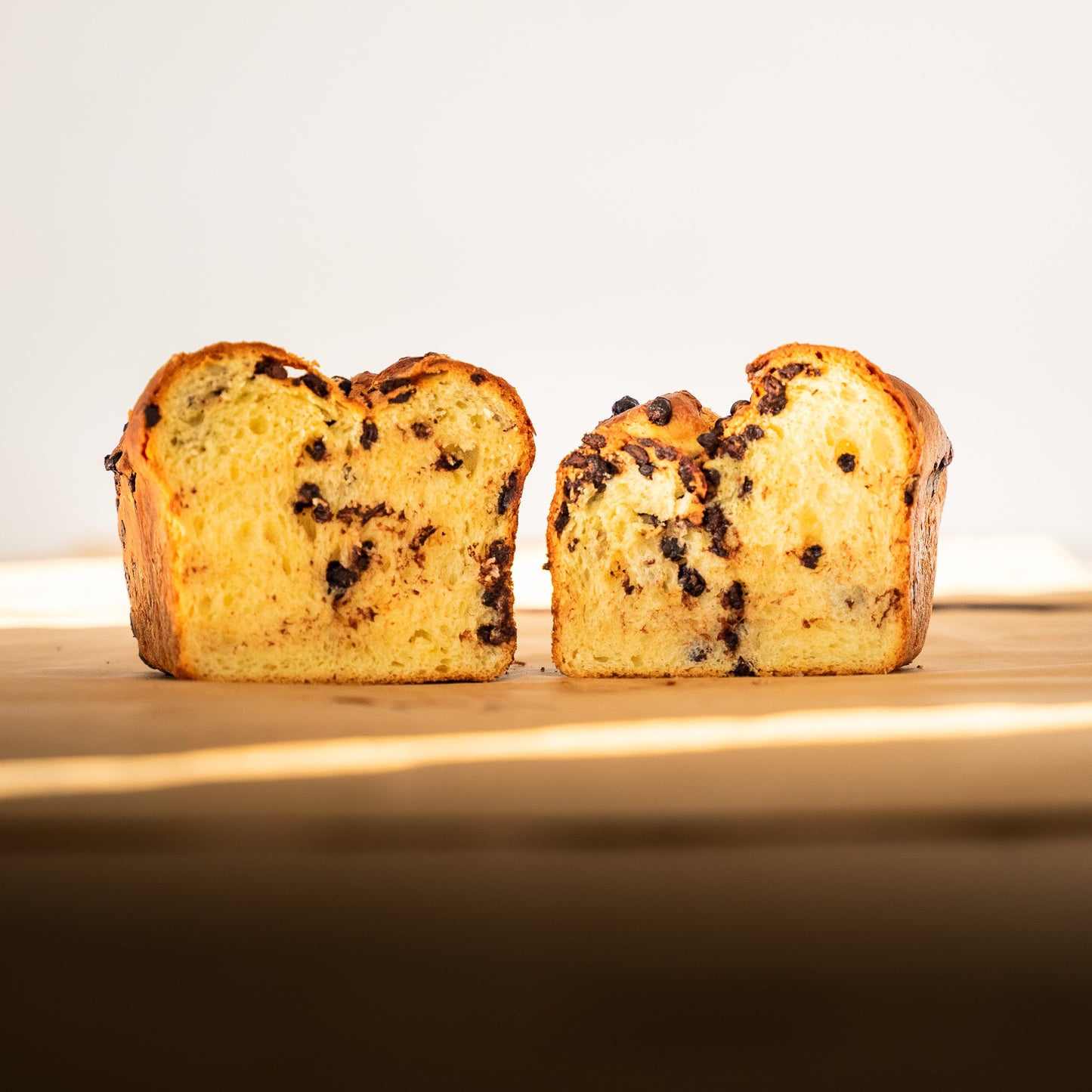 Sliced chocolate brioche revealing its soft texture and rich chocolate chunks.
