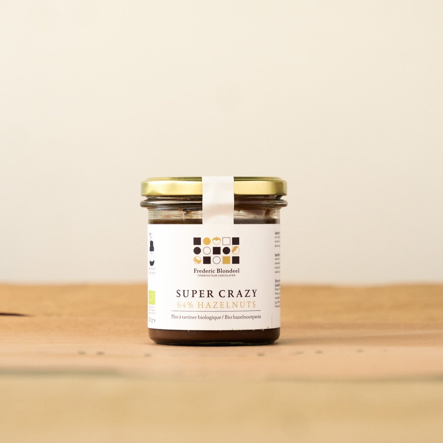 Super Crazy 64% organic hazelnut chocolate spread by Frédéric Blondeel, featuring 64% hazelnuts, dark chocolate, and coconut flower sugar, palm oil-free for a healthier indulgence