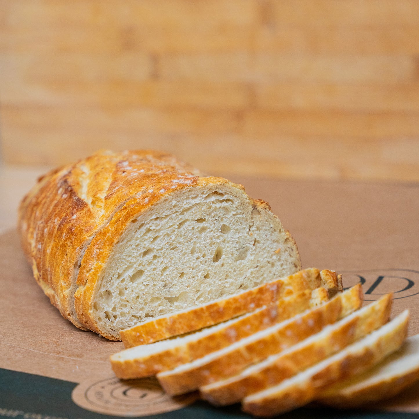 Sliced white sourdough bread with a crispy crust and soft, airy crumb, perfect for any meal.