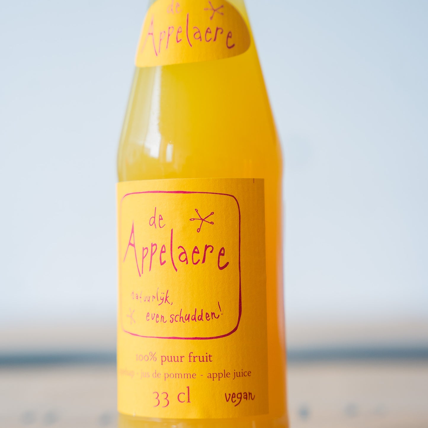 A close-up of the Appelaere pure apple juice label, highlighting its premium branding and rich golden color.
