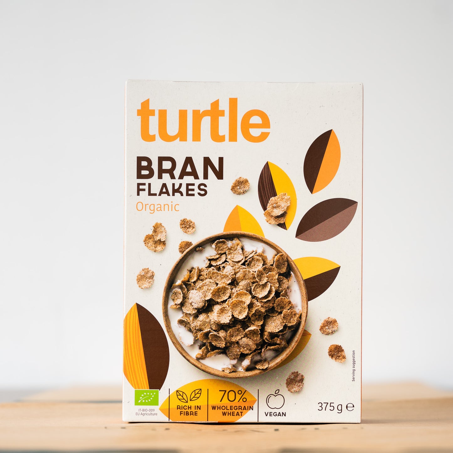 A box of Turtle Bran Flakes cereal on a table, showcasing its high-fiber, organic breakfast benefits with crunchy wheat bran flakes.