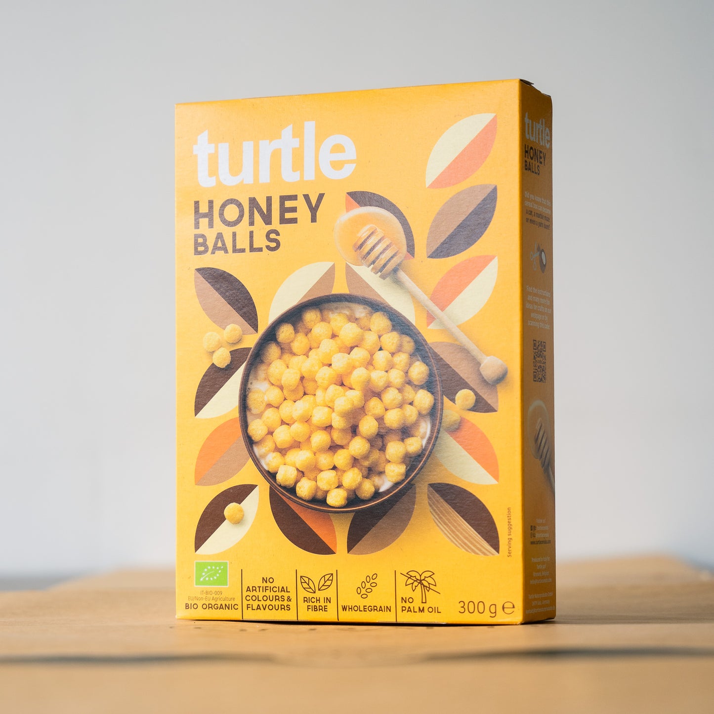 A box of organic Honey Balls cereal on a table, showcasing a healthy breakfast option with whole grains and less sugar