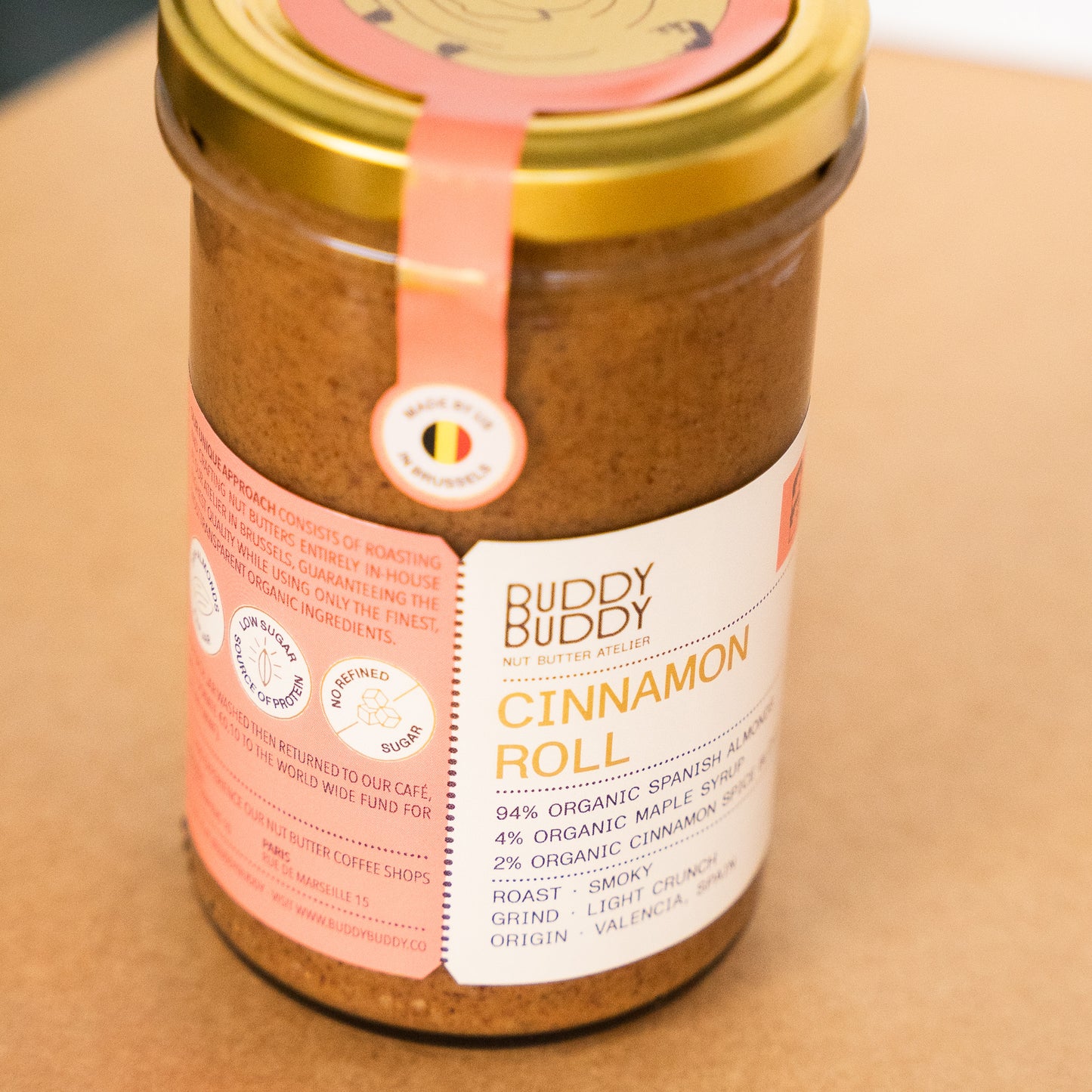 Close-up from Buddy Buddy cinnamon roll almond butter in a glass jar, crafted with organic Spanish almonds, maple syrup, and cinnamon spice