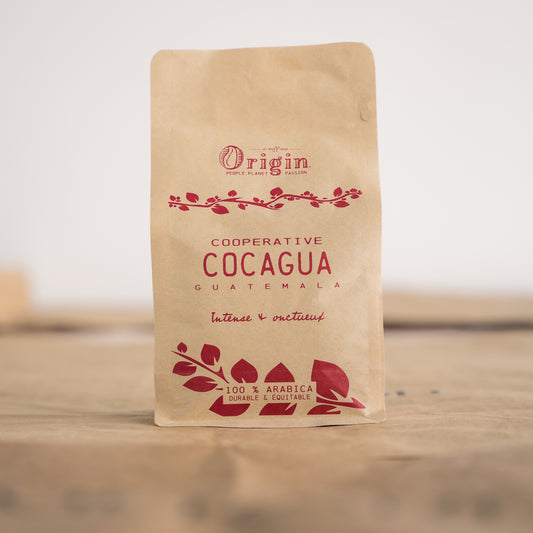 Coffee beans sourced from the cooperative Cocagua in Guatemala into a Origin Coffee packaging.