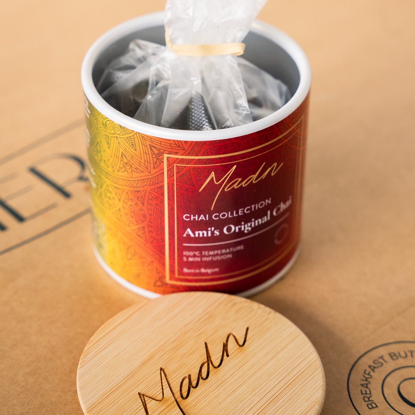 Madn Ami's Original Chai from the Chai Collection in a vibrant red tin with a bamboo lid, offering a rich and spiced tea blend inspired by traditional flavors.