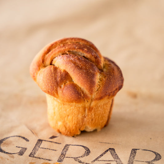 An appetising Cinnamon Roll resting on top of a Gérard reusable paper.