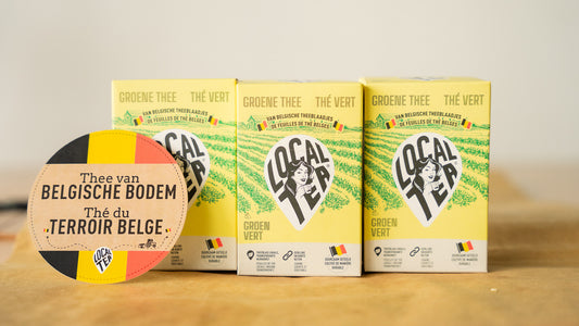 Three green tea packages placed next to each other with the writing "Tea from Belgian territory".