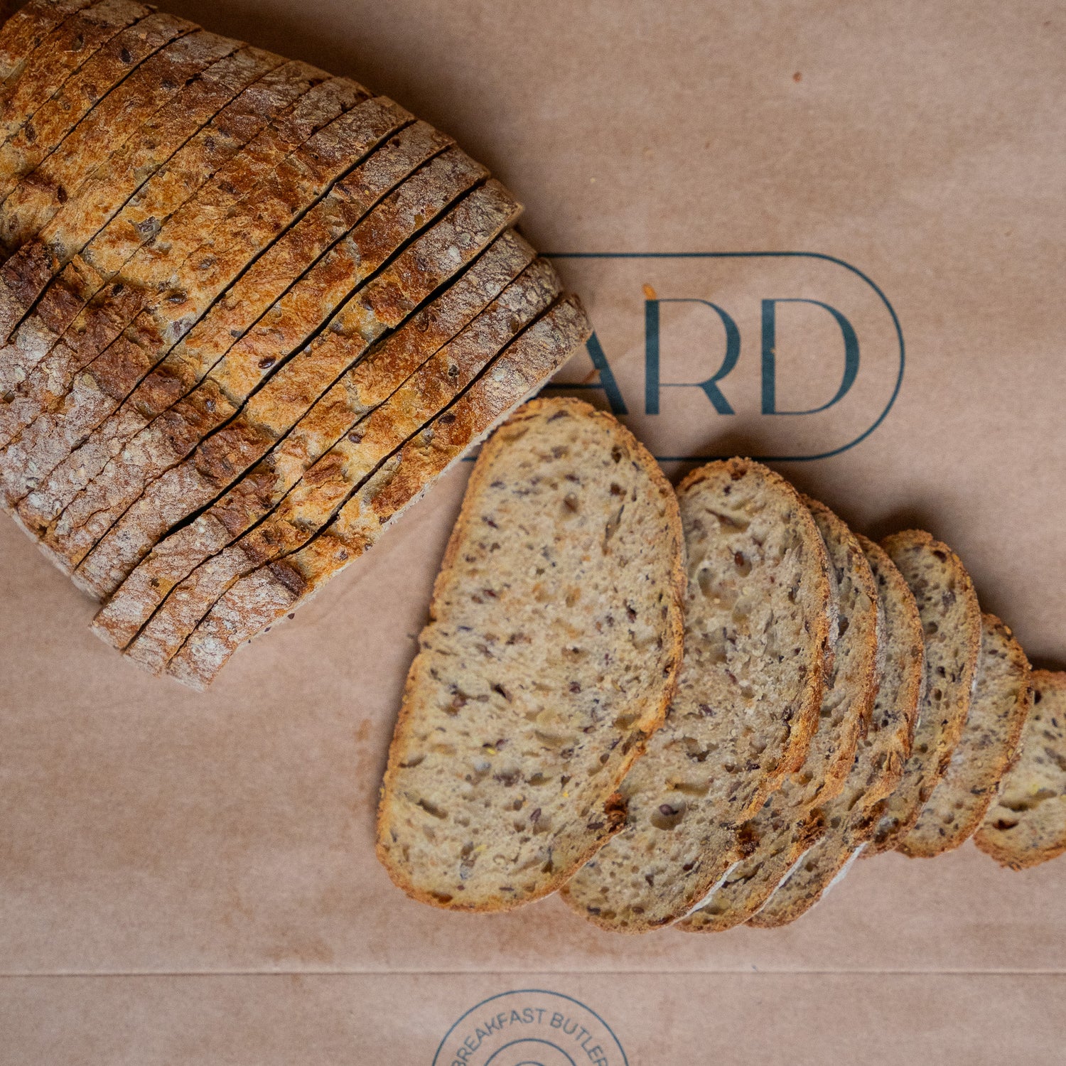 Sliced multiseed sourdough bread with a rustic crust and airy texture, perfect for nutritious meals