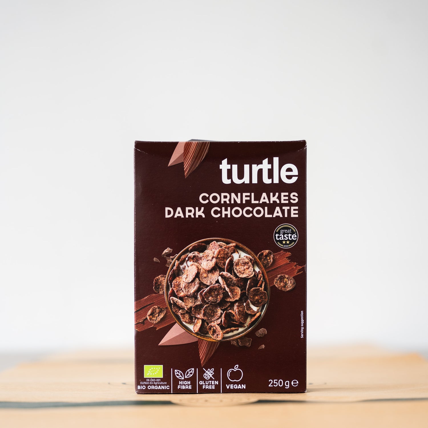 A close-up of Turtle Cornflakes with dark chocolate, emphasizing their organic, gluten-free nature and crunchy appeal.