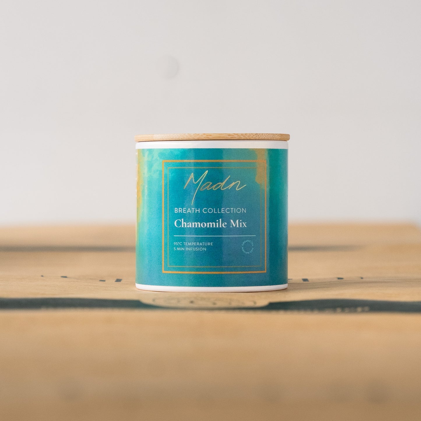 Madn Chamomile Mix from the Breath Collection in a serene blue-green tin with a bamboo lid, offering a calming and soothing herbal tea blend